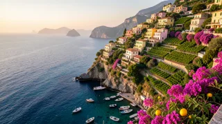 Pastel Amalfi Coast village stacked on a cliff above a turquoise harbour at golden hour with fishing boats